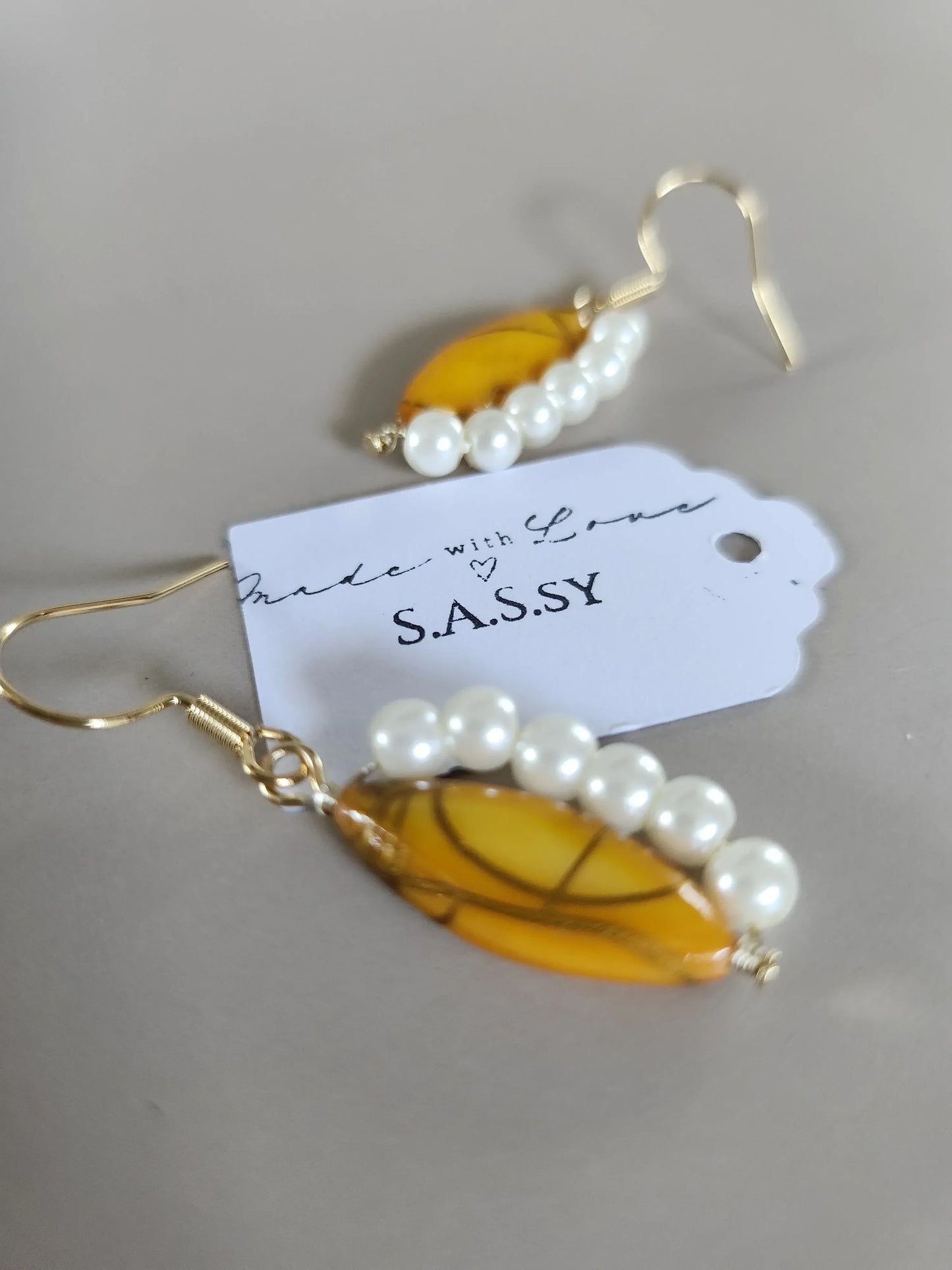 Pearl and leaf-shaped yellow shell bead earrings