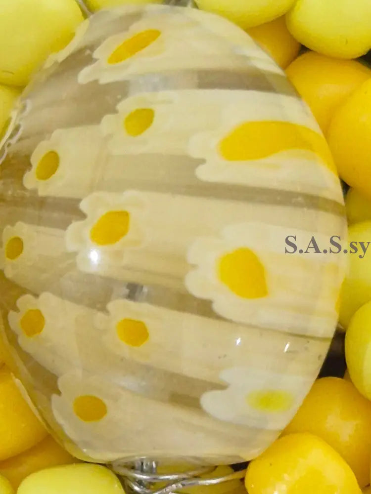 Yellow glass bead with floral pattern