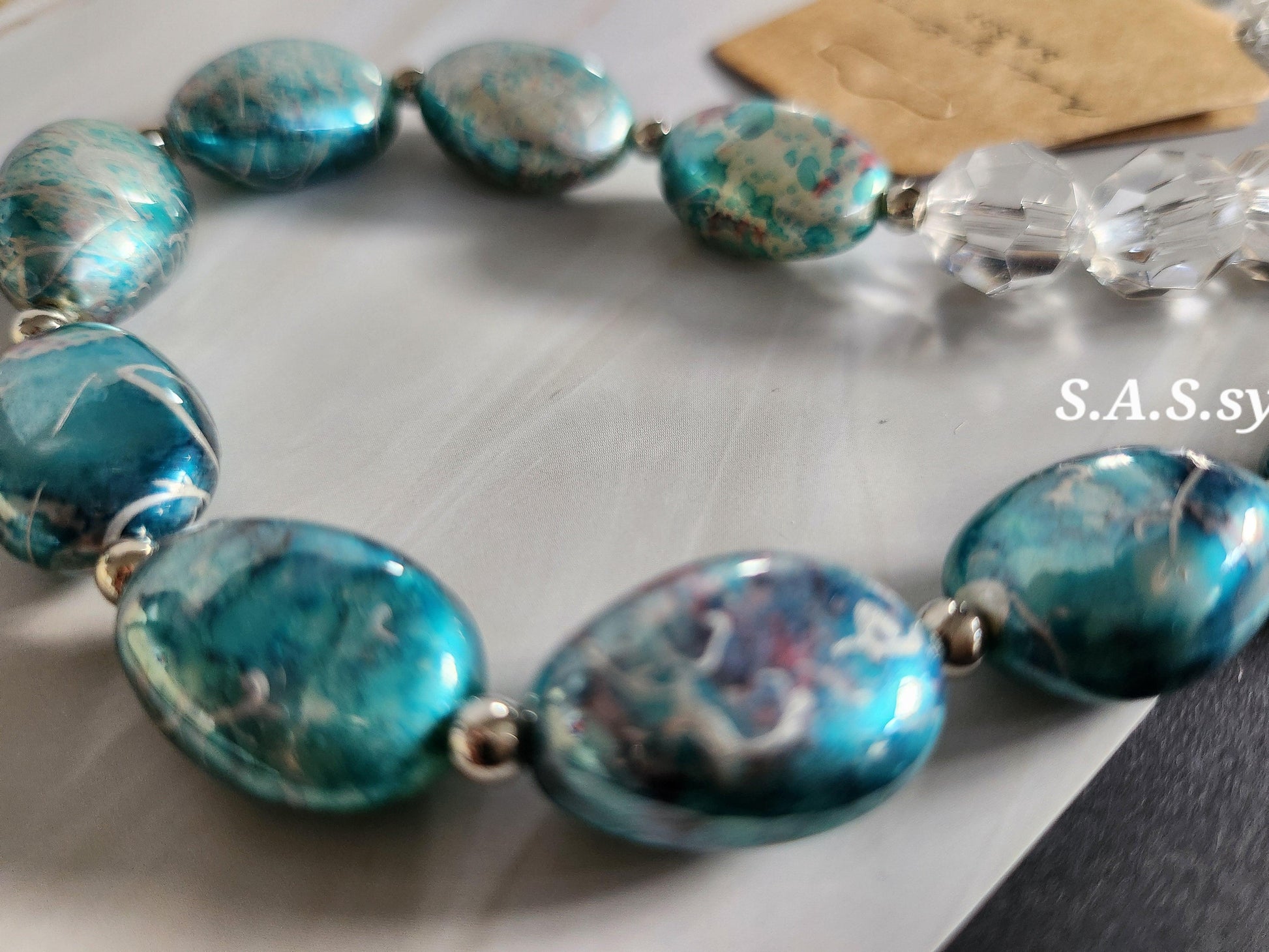 close up view of turquoise foiled oval bead with clear glass seed beaded necklace - Sassy by Sharmin Aziz