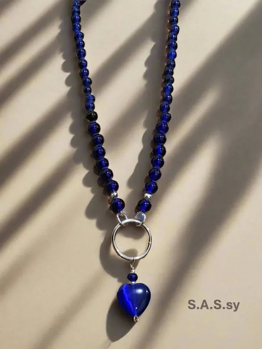 Navy glass bead necklace with a silver accent and navy heart shaped pendant 