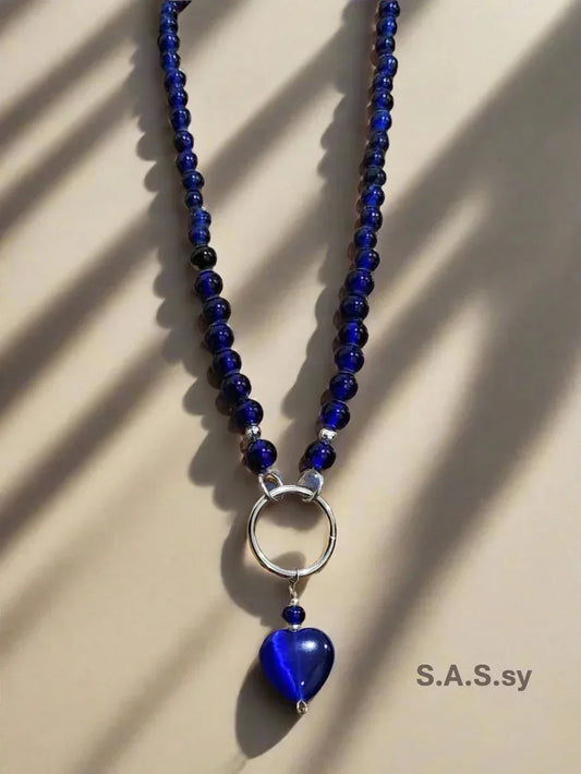 Navy glass bead necklace with a silver accent and navy heart shaped pendant 