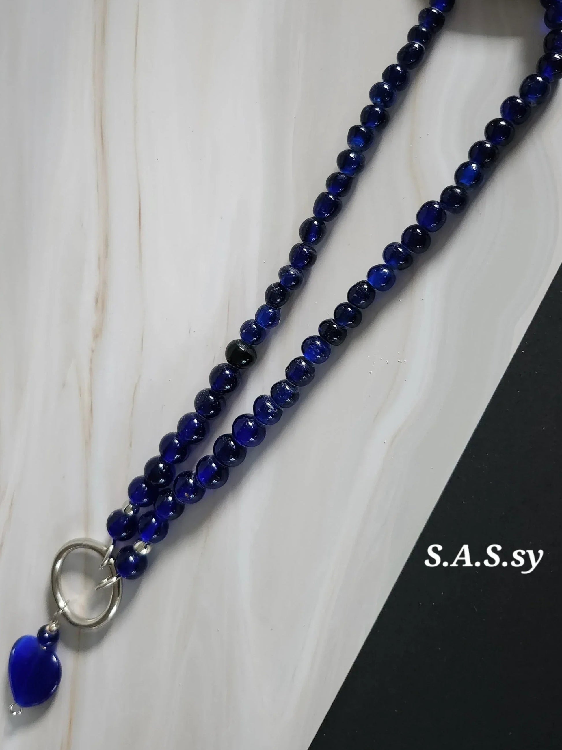 Navy glass bead necklace with a silver accent and navy heart shaped pendant 