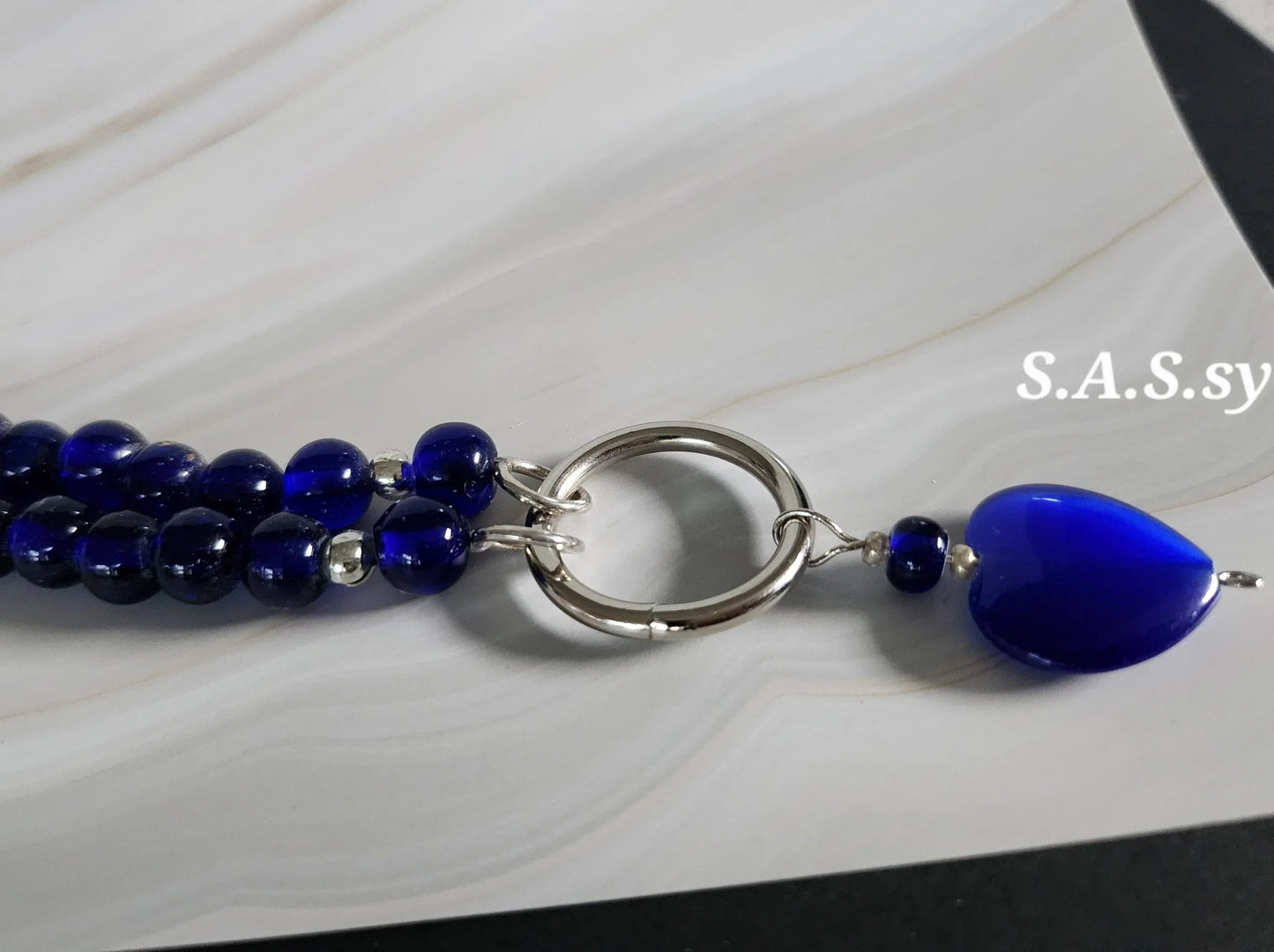 Navy glass bead necklace with a silver accent and navy heart shaped pendant 