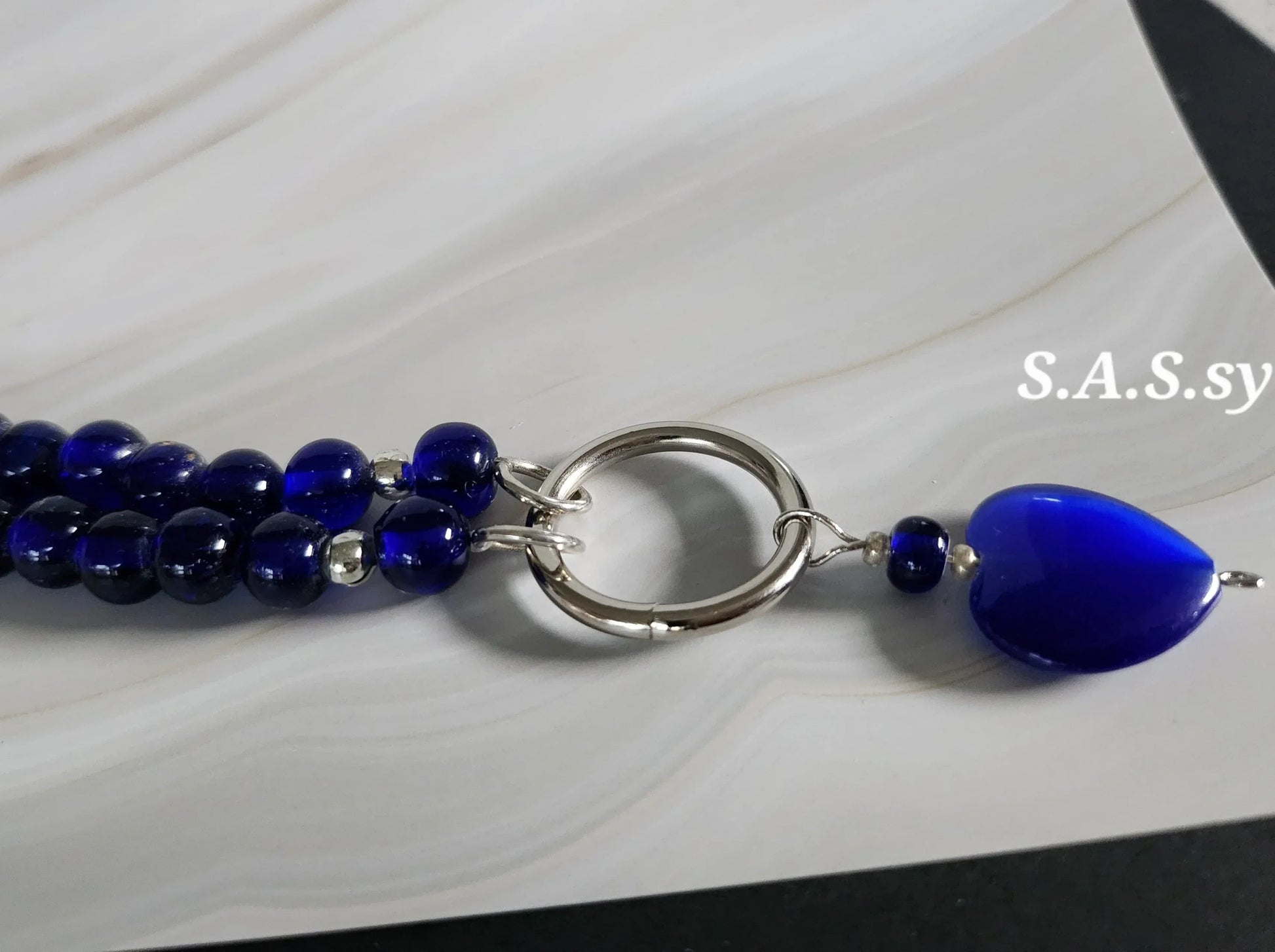 Navy glass bead necklace with a silver accent and navy heart shaped pendant 