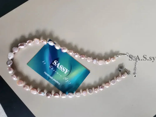 Blush pink Pearl necklace  on a light gray background