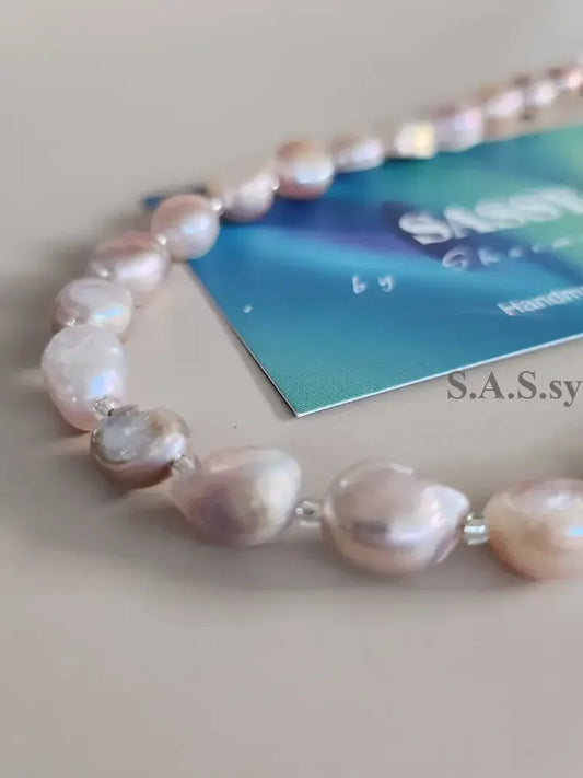 Blush pink Pearl necklace  on a light gray background