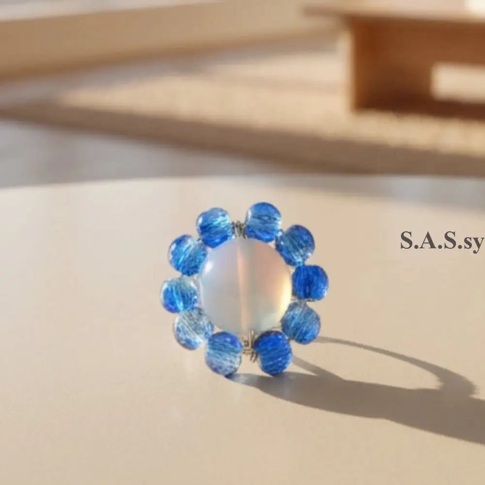 Blue beaded ring with a central opalite stone 