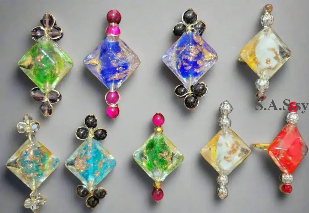 Nine vivid coloured cocktail rings on a light surface - Sassy by Sharmin Aziz 